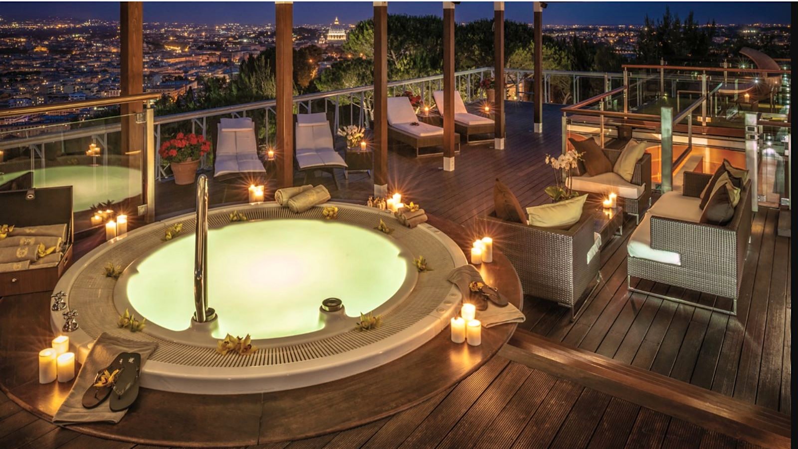 A deck with a Jacuzzi tub at the Rome Hotel Cavalieri, overlooking Rome at night